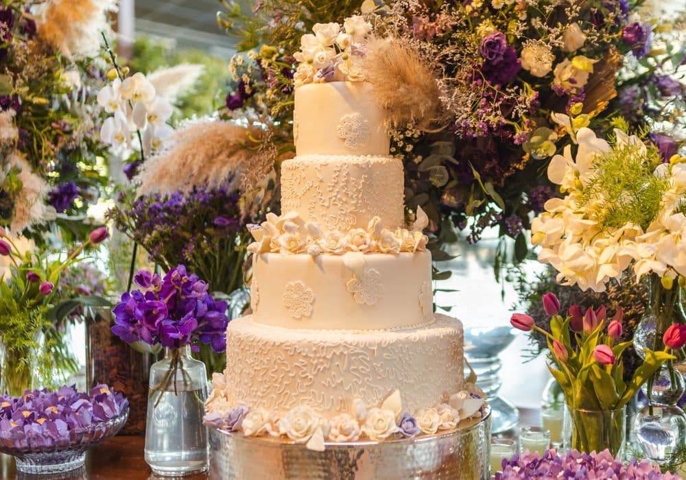 Close-up of luxury wedding cake design elements — hand-piped detail and textured finish